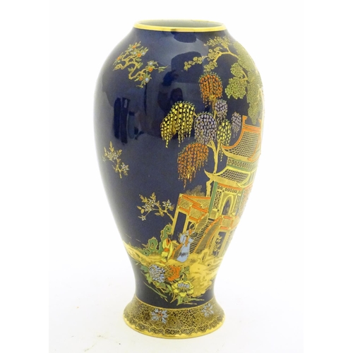 99 - A Wiltshaw and Robinson Carlton Ware baluster vase decorated with a landscape scene with pagodas, br... 