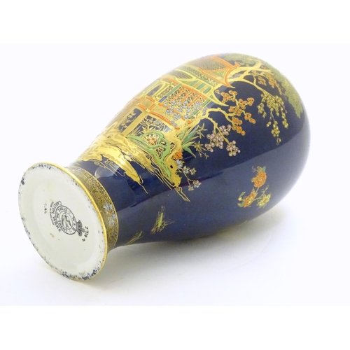 99 - A Wiltshaw and Robinson Carlton Ware baluster vase decorated with a landscape scene with pagodas, br... 