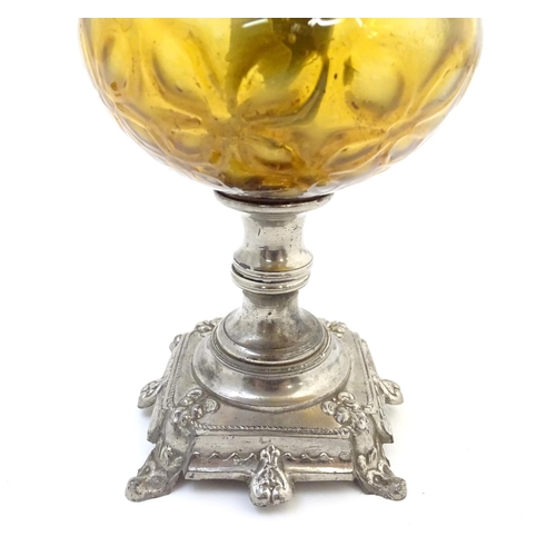 1523 - A late 19thC / early 20thC Continental oil lamp wit amber glass reservoir and clear glass chimney. T... 