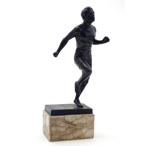 845 - A 20thC cast model of a man running on a marble base. Approx. 10 3/4