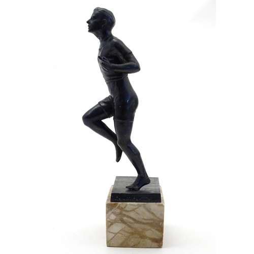 845 - A 20thC cast model of a man running on a marble base. Approx. 10 3/4