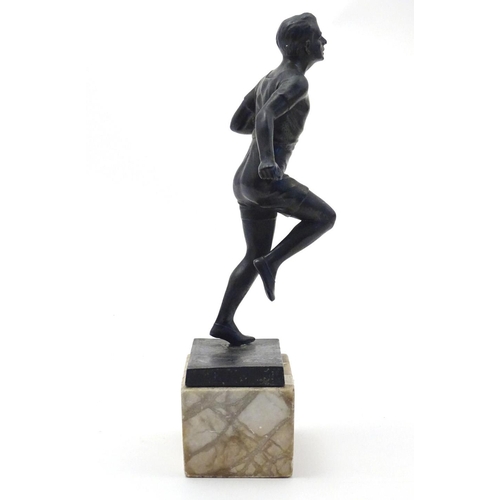 845 - A 20thC cast model of a man running on a marble base. Approx. 10 3/4