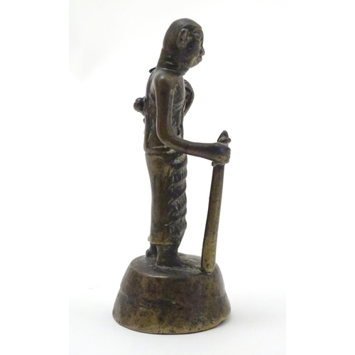 847 - An Oriental brass figure modelled as a man with a staff. Approx. 4 1/2