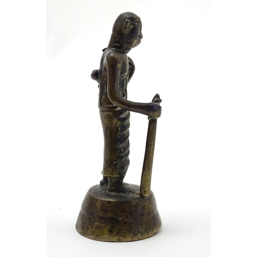 847 - An Oriental brass figure modelled as a man with a staff. Approx. 4 1/2