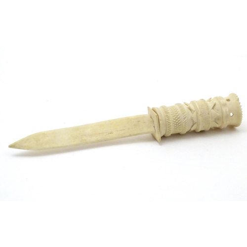 851 - A late 19thC bone letter opener with a carved handle. Approx. 8 1/2