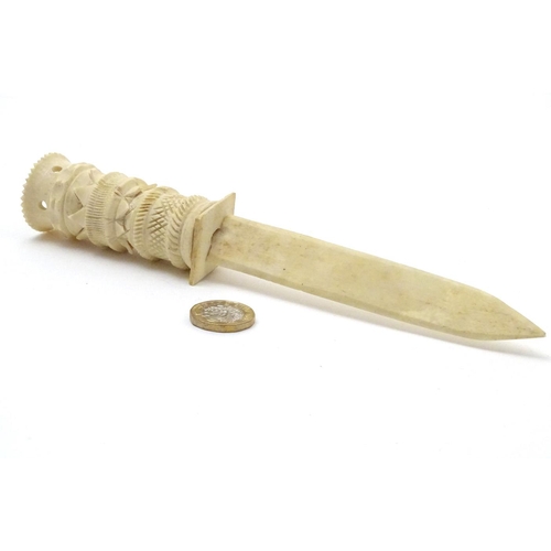 851 - A late 19thC bone letter opener with a carved handle. Approx. 8 1/2