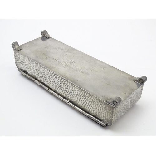 816 - An Art Deco pewter table box of rectangular form with a hinged lid and hammered decoration. Stamped ... 