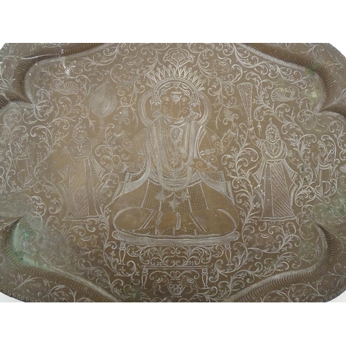 820A - A 20thC Indian brass tray with lobed rim, engraved with deity Ganesha with attendants and scrolling ... 