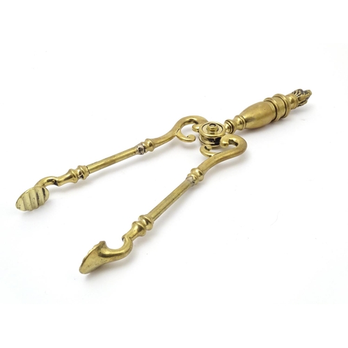 821 - Victorian brass fire tongs with flame finial. Approx. 17