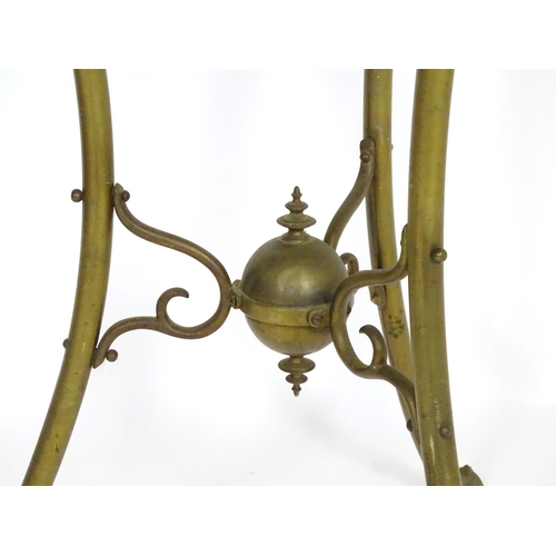 819 - A 20thC brass tripod jardiniere stand with dragon head detail. Approx. 31