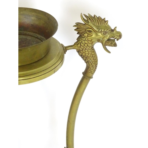 819 - A 20thC brass tripod jardiniere stand with dragon head detail. Approx. 31