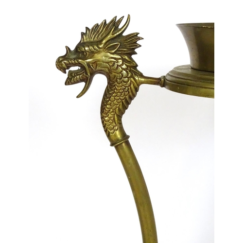 819 - A 20thC brass tripod jardiniere stand with dragon head detail. Approx. 31