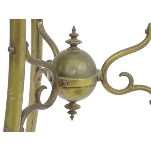 819 - A 20thC brass tripod jardiniere stand with dragon head detail. Approx. 31