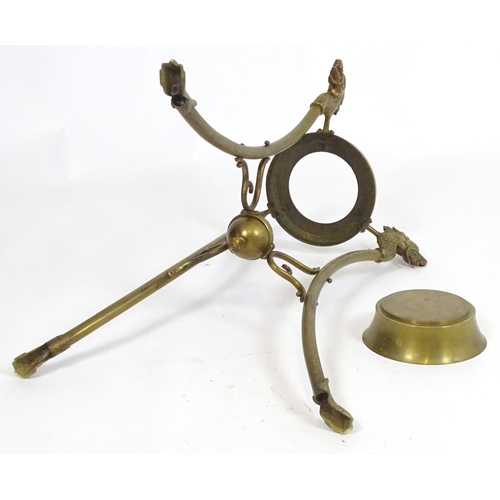 819 - A 20thC brass tripod jardiniere stand with dragon head detail. Approx. 31