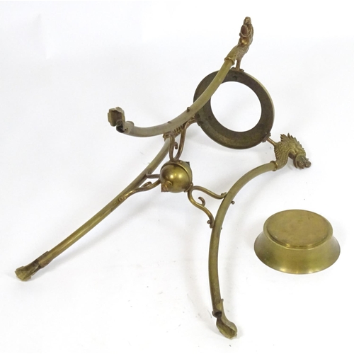 819 - A 20thC brass tripod jardiniere stand with dragon head detail. Approx. 31