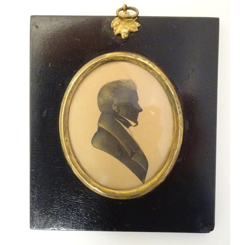 829 - A 19thC oval watercolour silhouette portrait miniature of a man with gilt highlights. Approx. 5 3/4