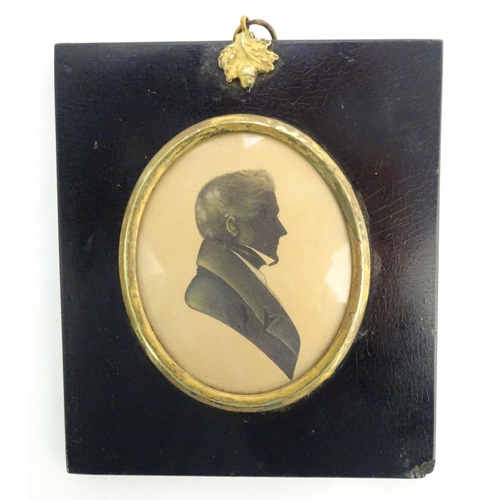 829 - A 19thC oval watercolour silhouette portrait miniature of a man with gilt highlights. Approx. 5 3/4