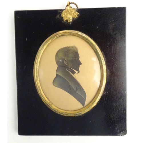 829 - A 19thC oval watercolour silhouette portrait miniature of a man with gilt highlights. Approx. 5 3/4