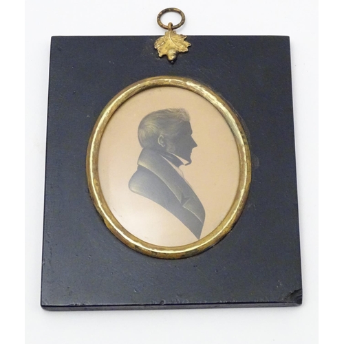 829 - A 19thC oval watercolour silhouette portrait miniature of a man with gilt highlights. Approx. 5 3/4