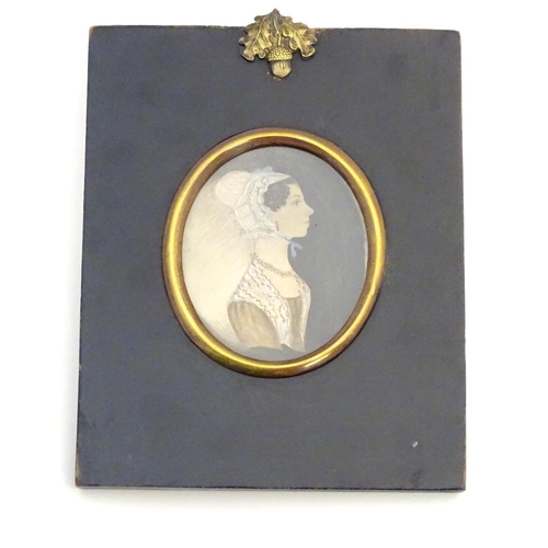 831 - A 19thC oval watercolour portrait miniature depicting a young lady wearing a bonnet. Approx. 6 1/4