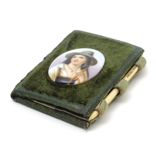 841 - A 19thC folding sewing / needle case with applied cabochon depicting an alpine boy. Approx. 3 1/4