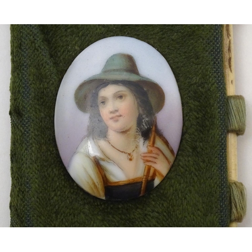 841 - A 19thC folding sewing / needle case with applied cabochon depicting an alpine boy. Approx. 3 1/4