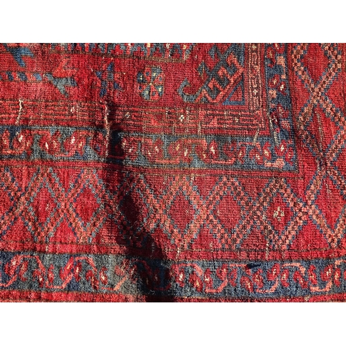 1530 - Carpet / Rug : A large rug with a red ground and 8 central medallions of geometric form, with blue, ... 