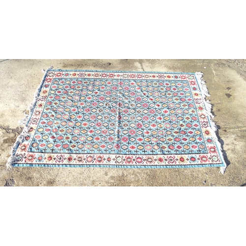 1532 - Carpet / Rug : A large Kilim rug with blue ground having geometric medallion decoration and white bo... 