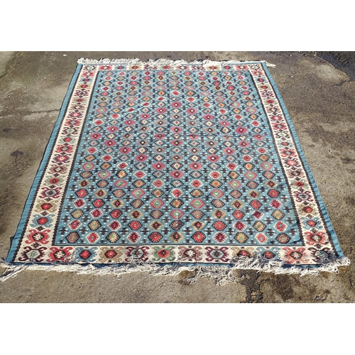 1532 - Carpet / Rug : A large Kilim rug with blue ground having geometric medallion decoration and white bo... 