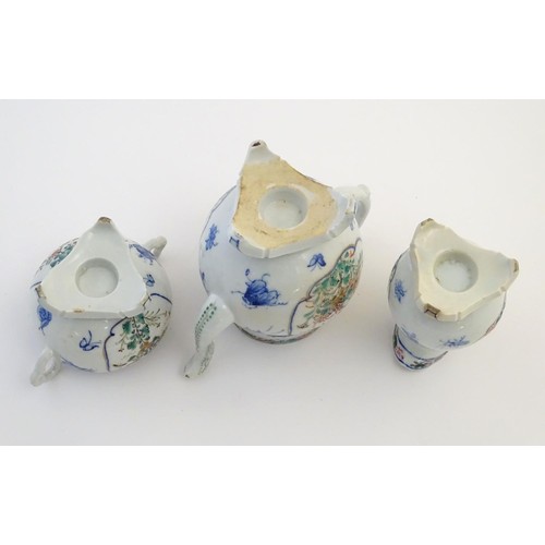 12 - A Japanese teapot, twin handled sugar bowl and milk jug decorated with hand painted insects and pane... 