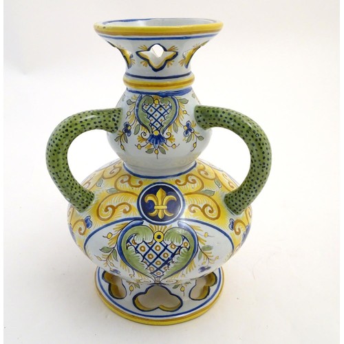 75 - A Continental faience double gourd vase with three loop handles, reticulated openwork to rim and bas... 