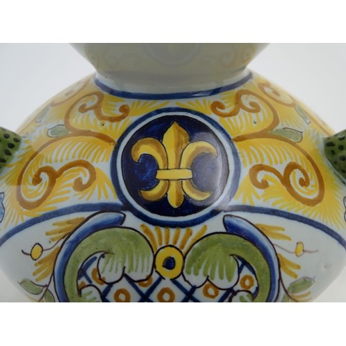 75 - A Continental faience double gourd vase with three loop handles, reticulated openwork to rim and bas... 