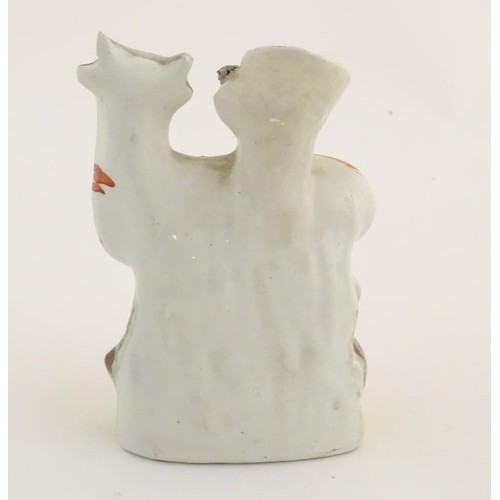 76 - A 19thC flatback Staffordshire Pottery spill vase formed as a milk maid milking a cow. Approx. 4 3/4... 