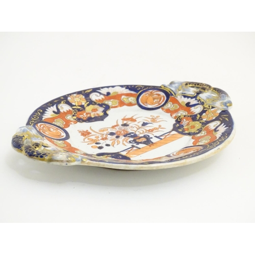 79A - An Ashworth's Ironstone China twin handled plate decorated in the Imari palette with floral motifs, ... 