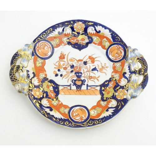 79A - An Ashworth's Ironstone China twin handled plate decorated in the Imari palette with floral motifs, ... 