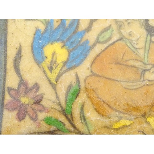 93 - A 19thC rectangular Persian tile with hand painted decoration depicting a seated man playing a music... 