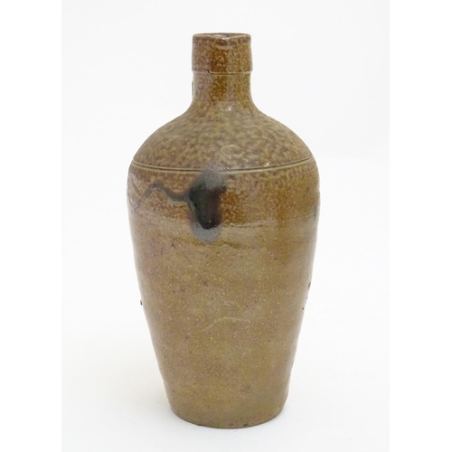 100 - A studio pottery jug with drip glaze, together with a stoneware wine flagon with impressed marks Cam... 