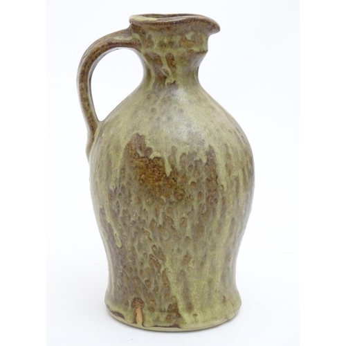 100 - A studio pottery jug with drip glaze, together with a stoneware wine flagon with impressed marks Cam... 