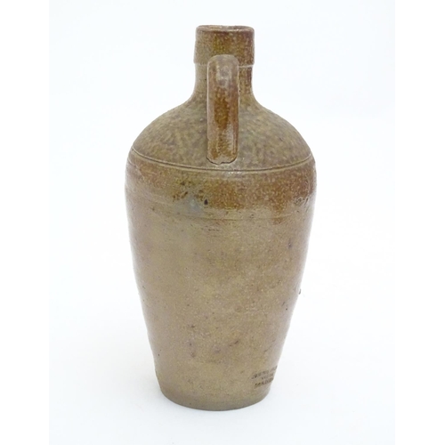 100 - A studio pottery jug with drip glaze, together with a stoneware wine flagon with impressed marks Cam... 