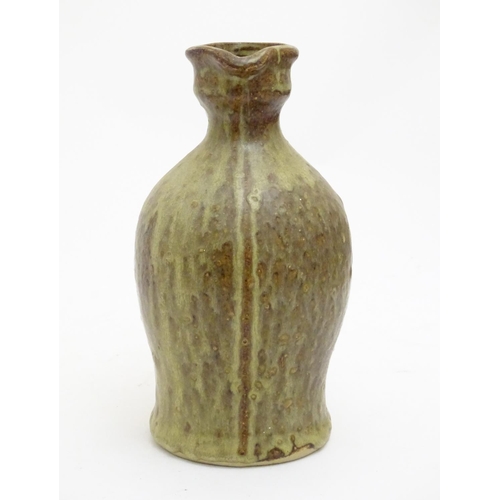 100 - A studio pottery jug with drip glaze, together with a stoneware wine flagon with impressed marks Cam... 