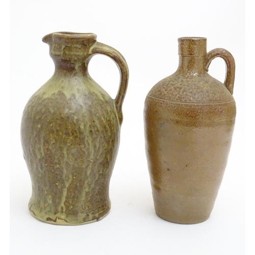 100 - A studio pottery jug with drip glaze, together with a stoneware wine flagon with impressed marks Cam... 