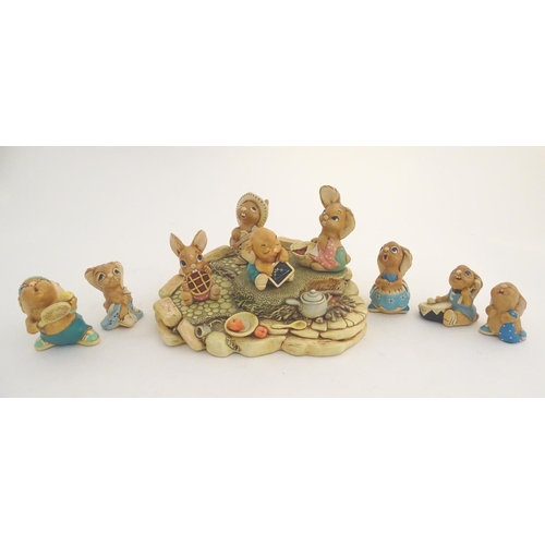 155 - A quantity of Pendelfin rabbit figures and display stand. Tallest figure approx. 4