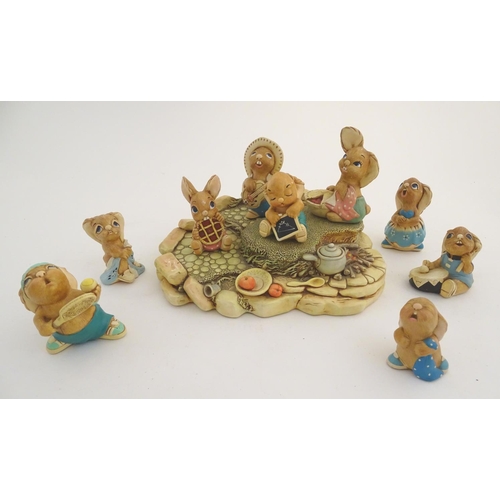 155 - A quantity of Pendelfin rabbit figures and display stand. Tallest figure approx. 4