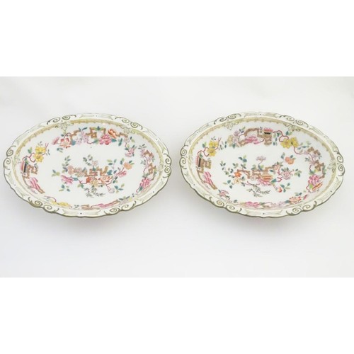 159 - A pair of 19thC oval dishes with hand painted decoration of oriental style stylised scrolling flower... 