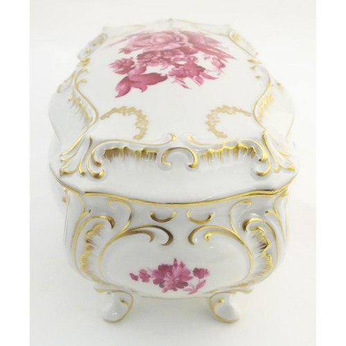 171 - A German Graf von Henneberg porcelain casket and cover decorated with pink flowers and foliage and g... 