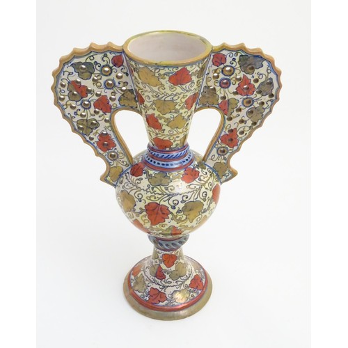 175 - A late 20thC Italian Gu-shaped vase with large wavy edged handles with pierced decoration, decorated... 