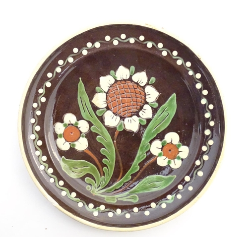 180 - Two items of Continental studio pottery comprising a jug and a plate with floral and foliate detail.... 