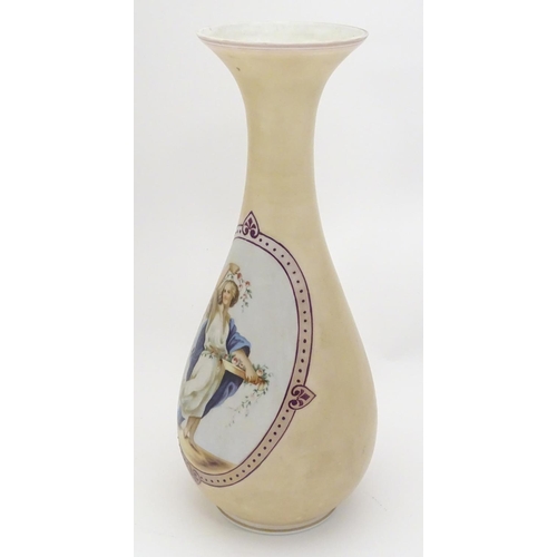 200 - A late 19th / early 20thC Continental milk glass vase with hand painted enamel decoration depicting ... 