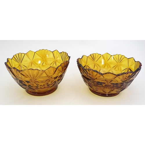 227 - Two amber glass bowls with cut decoration. approx. 6