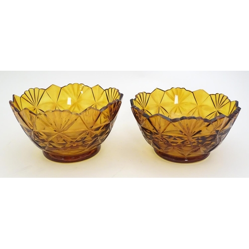 227 - Two amber glass bowls with cut decoration. approx. 6